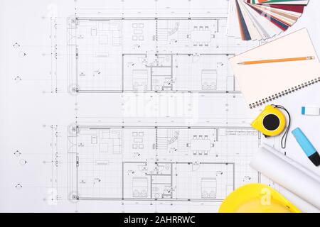 Construction plans with helmet and drawing tools on blueprints Stock Photo
