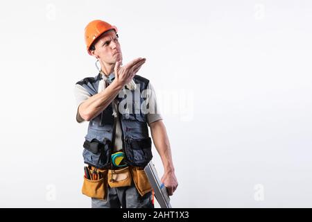 Handsome man in a white dress. Takes off the glove. Stock Photo