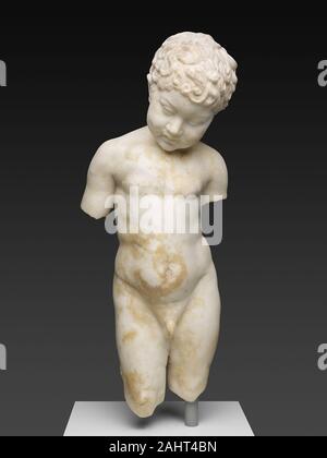 Ancient Roman. Statue of a Young Boy. 1 AD–100 AD. Italy. Marble Representations of children were popular in both public and private art during the Roman imperial period. It is uncertain whether this statue is a portrait of a specific child or was inspired by a basic type that had originated among the Greeks several centuries earlier. The boy, who has a head of curly hair, rounded cheeks, and a pudgy belly, gazes downward and to the side. It is possible that he is admiring a pet at his feet, as Roman statues of children frequently depict them with companion animals such as geese, doves, and pu Stock Photo