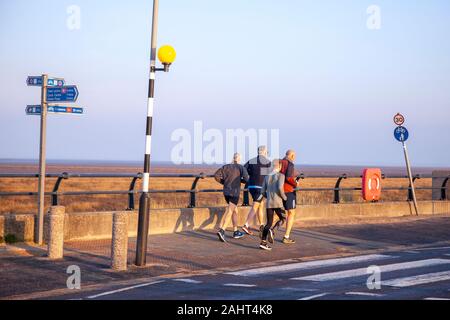 Southport, Merseyside. UK Weather;  01 Jan 2020. New Me New You.  New Year people exercising on the seafront promenade at the sun rises on a new decade.  Credit:MediaWorldImages/AlamyLiveNews Stock Photo