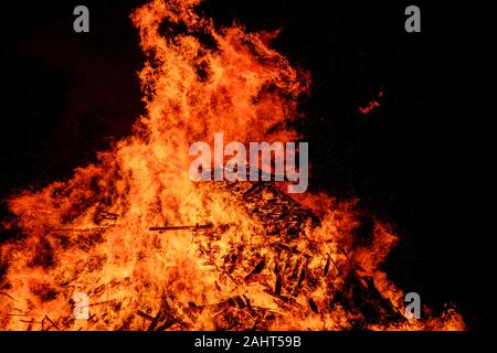 Biggar, Scotland 31st December 2019: Huge flames from the Biggar Hogmanay bonfire lit at 9.30pm on Hogmanay by local resident Bobby Boyd MBE.  This is Stock Photo