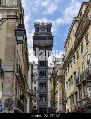 Colorful buildings and Santa Justa elevator. Famous tourist attraction in Chiado District. Sunny day in summer. Travel and transport concept. Lisbon, Stock Photo