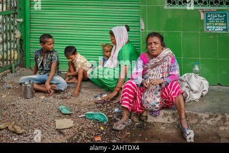 Candid portrait of poor homeless family, adults and children, living on streets near Chandni Chowk, Delhi, India. Stock Photo