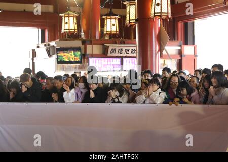 Tokyo, Japan. 1st Jan, 2020. People make wishes during Hatsumode, or their first temple visit of the year, at Senso-ji temple in Asakusa area, Tokyo, Japan, Jan. 1, 2020. Credit: Du Xiaoyi/Xinhua/Alamy Live News Stock Photo