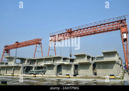 (200101) -- DHAKA, Jan. 1, 2020 (Xinhua) -- Photo taken on Dec. 31, 2019 shows the plant where the box girders of elevated railway of Padma Bridge Rail Link Project are manufactured at Keraniganj on the outskirts of capital Dhaka, Bangladesh. About two months into the commencement of a project linking capital Dhaka's central Kamalapur railway station with a western Bangladesh district, the Chinese engineers on Tuesday successfully installed the first box girder of the country's longest elevated railway. The 17-km elevated railway is a part of China-financed Padma Bridge Rail Link Project which Stock Photo