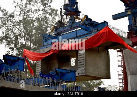 (200101) -- DHAKA, Jan. 1, 2020 (Xinhua) -- The box girder of elevated railway of Padma Bridge Rail Link Project is installed at Keraniganj on the outskirts of capital Dhaka, Bangladesh, Dec. 31, 2019. About two months into the commencement of a project linking capital Dhaka's central Kamalapur railway station with a western Bangladesh district, the Chinese engineers on Tuesday successfully installed the first box girder of the country's longest elevated railway. The 17-km elevated railway is a part of China-financed Padma Bridge Rail Link Project which Bangladeshi Prime Minister Sheikh Hasina Stock Photo