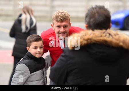 Nottingham, UK. 1st Jan 2020. Joe Worrall (4) of Nottingham Forest has his photo taken with a young Forest supporter during the Sky Bet Championship match between Nottingham Forest and Blackburn Rovers at the City Ground, Nottingham on Wednesday 1st January 2020. (Credit: Jon Hobley | MI News) Photograph may only be used for newspaper and/or magazine editorial purposes, license required for commercial use Credit: MI News & Sport /Alamy Live News Stock Photo