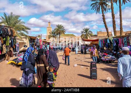 Tamegroute, Morocco - October 24, 2015. Moroccan shoppers walk through the weekly Saturday outdoor market near the town mosque. Stock Photo