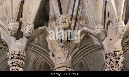 YORK CITY ENGLAND MINSTER INTERIOR CHAPTER HOUSE HEADS AND CARVINGS FOUR HEADS ONE WITH HAND IN HIS MOUTH AND CARVINGS OF LEAVES Stock Photo