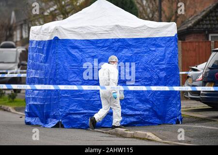NUMBER PLATE PIXELATED BY PA PICTURE DESK Forensic officers at the scene in Duffield, Derbyshire after two people were found dead in a house. Stock Photo