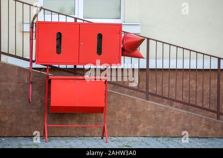 Red fire protection utencils outsine a building. Stock Photo