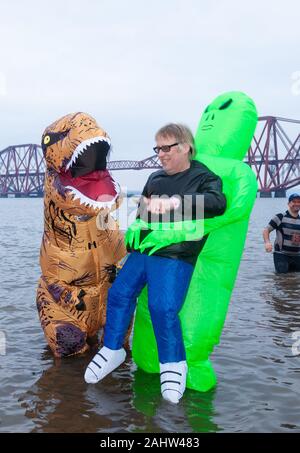 South Queensferry, Edinburgh, Scotland. 1st Jan 2020..  Revellers braving the cold water for the Traditional New Years Day Loony Dook with the Iconic Forth Bridge in the Background Credit: Richard Newton/Alamy Live News Stock Photo