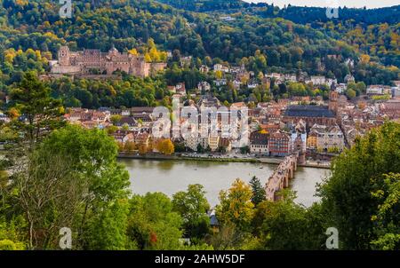 Close aerial panorama of Heidelberg's old town, the castle ruin on Königstuhl hill, the church Heiliggeistkirche and the Karl Theodor Bridge on Neckar... Stock Photo