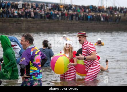 People take part in the Loony Dook New Year's Day dip in the Firth of ...