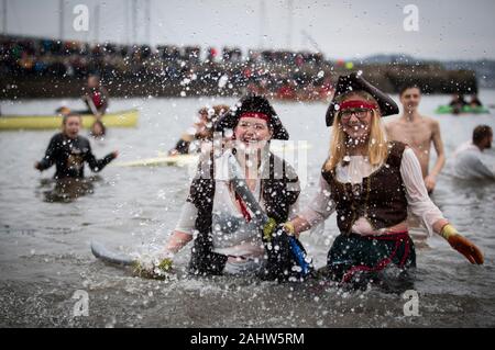 People take part in the Loony Dook New Year's Day dip in the Firth of ...