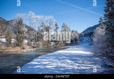 01 January 2020, Bavaria, Vorderriss: The Isar flows under trees covered with hoarfrost and snow. Photo: Lino Mirgeler/dpa Stock Photo