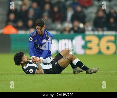 Newcastle, UK. 1st January 2020; St James Park, Newcastle, Tyne and Wear, England; English Premier League Football, Newcastle United versus Leicester City; Ayoze Perez of Leicester City holds the arms of DeAndre Yedlin of Newcastle United after he accidentally trod on and fouled him. - Strictly Editorial Use Only. No use with unauthorized audio, video, data, fixture lists, club/league logos or 'live' services. Online in-match use limited to 120 images, no video emulation. Credit: Action Plus Sports Images/Alamy Live News Stock Photo