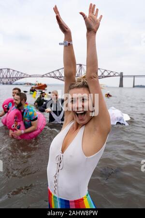 South Queensferry, Scotland, UK. 1st Jan 2020. People in fancy dress take the plunge into the Firth of Forth river during the annual New Year’s Day Loony Dook at South Queensferry. Iain Masterton/Alamy Live News Stock Photo