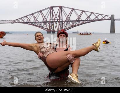 South Queensferry, Scotland, UK. 1st Jan 2020. People in fancy dress take the plunge into the Firth of Forth river during the annual New Year’s Day Loony Dook at South Queensferry. Iain Masterton/Alamy Live News Stock Photo