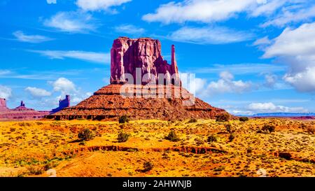 The towering red sandstone formation of West Mitten Butte in the Navajo Nation's Monument Valley Navajo Tribal Park desert landscape on AZ- UT border Stock Photo