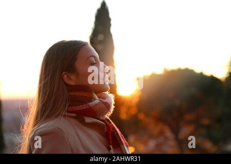Portrait of a girl breathing fresh air wearing jacket at sunset Stock Photo