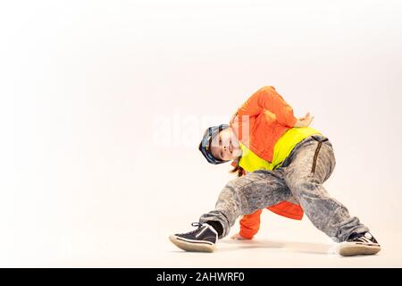 girl in a unique dance position, breakdance kid, a little girl performs breakdance, a child in a unique acrobatic dance pose Stock Photo