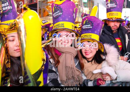 New York, United States. 01st Jan, 2020. Participants seen wearing 2020 glasses during the New Year's Eve celebrations at Times Square in New York City on January 1, 2020. (Photo by Ryan Rahman/Pacific Press) Credit: Pacific Press Agency/Alamy Live News Stock Photo