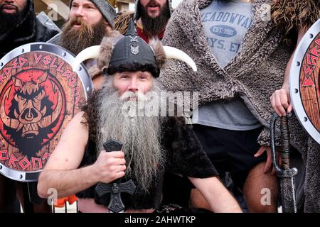 Toronto, Ontario, Canada. January 1st, 2020.  Bearded Villain in Viking costume one of 300 registered participants  “doing the dip” at Sunnyside Beach in Lake Ontario with temperature hovering around the freezing point. Stock Photo