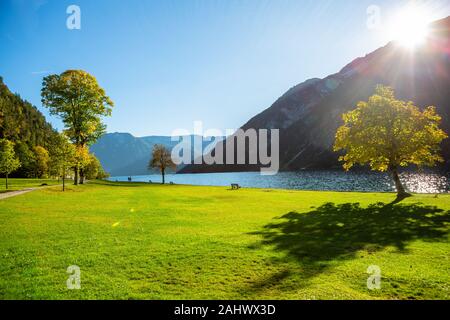 Shore of beautiful Achensee lake on sunny summer day with blue sky, Karwendel mountain range, Tyrol, Austria. Autumn Stock Photo