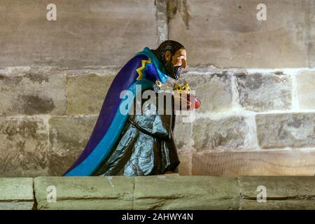 A Christmas decoration of Casper, one of the three wise men, carrying a gift of a gold crown. Stock Photo