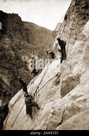 An historic,  1930s photograph showing the building of the Hoover Dam aka Boulder Dam , Black Canyon, Colorado River, on the border between the U.S. states of Nevada and Arizona. This view shows 'high fliers', construction men who worked on the rocks attached to ropes and safety lines.