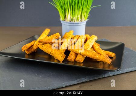 Plate of cheese straws Plate of stacked  cheese straws with chives, landscape Stock Photo
