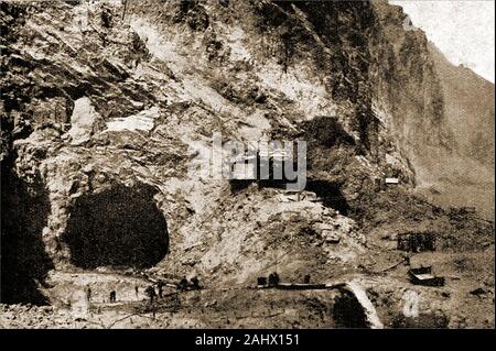 An historic,  1930s photograph showing the building of the Hoover Dam aka Boulder Dam, Black Canyon, Colorado River, on the border between the U.S. states of Nevada and Arizona. This view shows men preparing explosives in front of a giant diversion tunnel used to allow the river to flow whilst construction takes place. Stock Photo