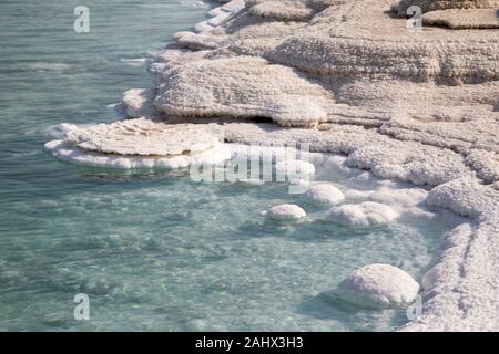 Salt formations in the Dead Sea form where fresh water flows into the saline water. They are exposed as water levels drop. Stock Photo