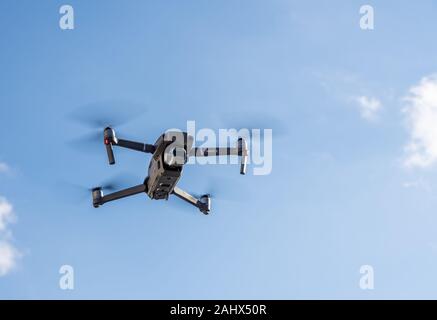 Morgantown, WV - 1 January 2020: DJI Mavic 2 Pro quadcopter or drone hovering in bright blue sky Stock Photo