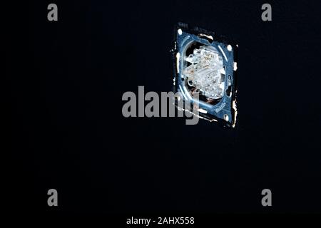 Double white light switches on a black wall background. Horizontal. Stock Photo