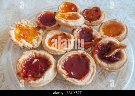 Homemade apricot and strawberry jam tarts on a plate Stock Photo