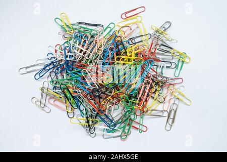 A pile of paper clips against a white background. Stock Photo