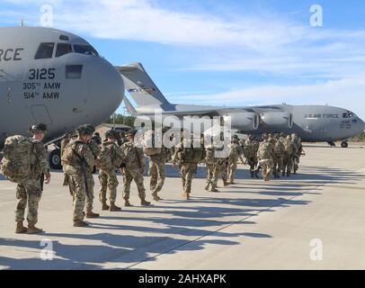 Fayetteville, United States. 01 January, 2020. U.S. Army Paratroopers with the 82nd Airborne Division, line up to load onto transport aircraft at Pope Army Airfield January 1, 2020 in Fayetteville, North Carolina. The Immediate Response Force is being deployment to Baghdad following violent protesters that attacked the U.S. Embassy compound.  Credit: Capt. Robyn Haake/Planetpix/Alamy Live News Stock Photo