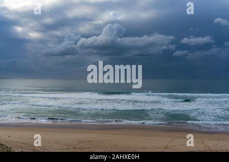 Beach view with storm coming. Ocean landscape with grey stormy clouds Stock Photo