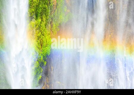 Close-up view of the Tumpak Sewu Waterfalls also known as Coban Sewu with a beautiful rainbow formed by refraction of light in water droplets. Stock Photo
