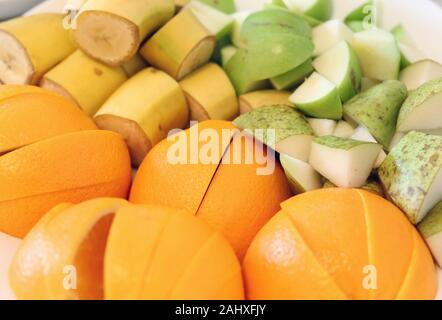 Closeup photo of plenty of fruit pieces. There is bananas, apples, pears and oranges in this photo. Vibrant, colorful image of a nutritious food. Stock Photo