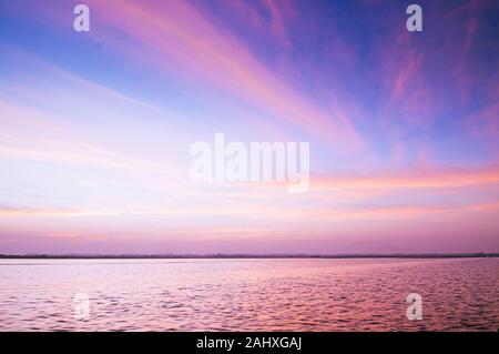 Beautiful sunrise or sunset sky over peaceful lake in Udon Thani - Thailand Stock Photo