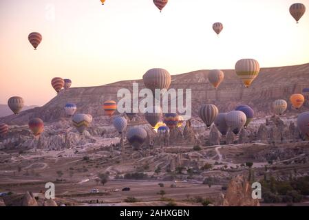 Goreme, Cappadocia, Turkey. Beautiful scenes in Goreme national park. Hundreds of colorful hot air balloons flying in the sky on sunrise. Stock Photo