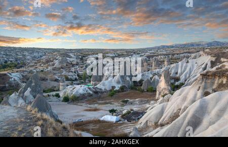 Goreme national park. Hundreds of colorful hot air balloons flying in the sky on sunrise. Rock formations in the valley Cappadocia, Turkey Stock Photo