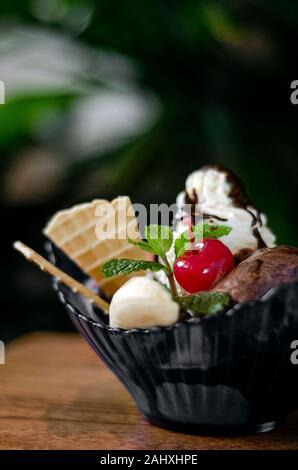 gourmet organic chocolate and strawberry ice cream sundae dessert with cherry and banana Stock Photo