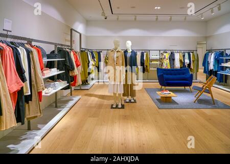 SINGAPORE - CIRCA APRIL, 2019: clothes on display at COS store in the Shoppes at Marina Bay Sands. Stock Photo