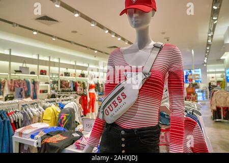 SINGAPORE - CIRCA APRIL, 2019: clothes on display at Guess the Shoppes at Marina Bay Sands. Stock Photo