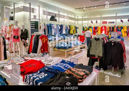 SINGAPORE - CIRCA APRIL, 2019: clothes on display at Guess the Shoppes at Marina Bay Sands. Stock Photo