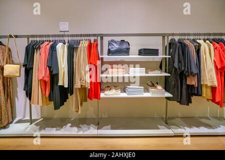 SINGAPORE - CIRCA APRIL, 2019: clothes on display at COS store in the Shoppes at Marina Bay Sands. Stock Photo